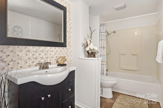 full bathroom featuring vanity, backsplash, toilet, and shower / bath combo with shower curtain