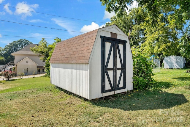 view of outbuilding with a lawn