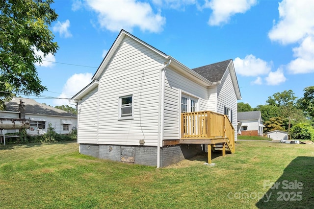 view of property exterior with a wooden deck and a yard