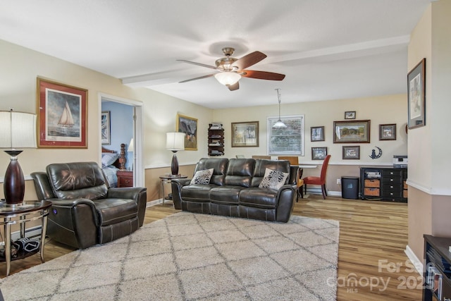 living room with wood-type flooring and ceiling fan