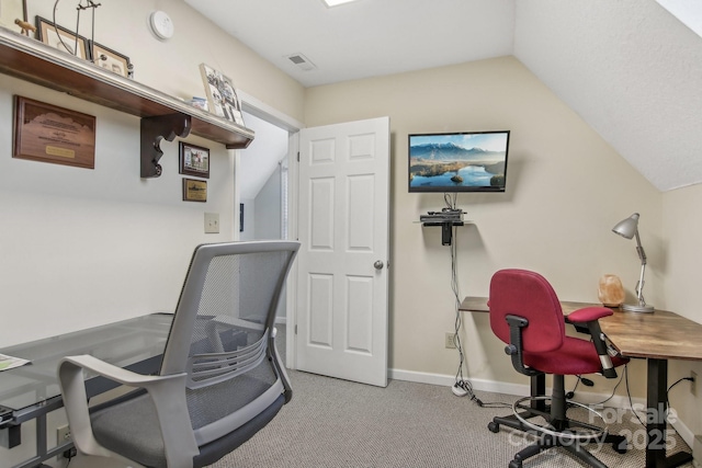 office space with lofted ceiling and light carpet