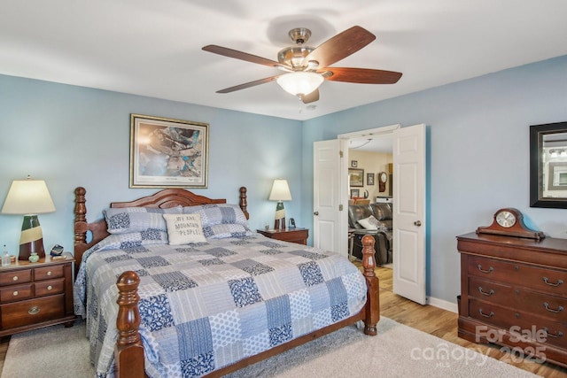 bedroom with ceiling fan and light hardwood / wood-style floors