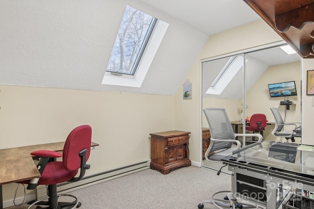 office with carpet floors and vaulted ceiling with skylight