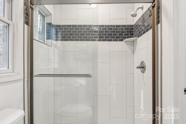 bathroom with toilet and walk in shower