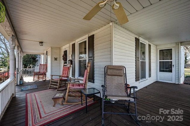 deck with ceiling fan and covered porch