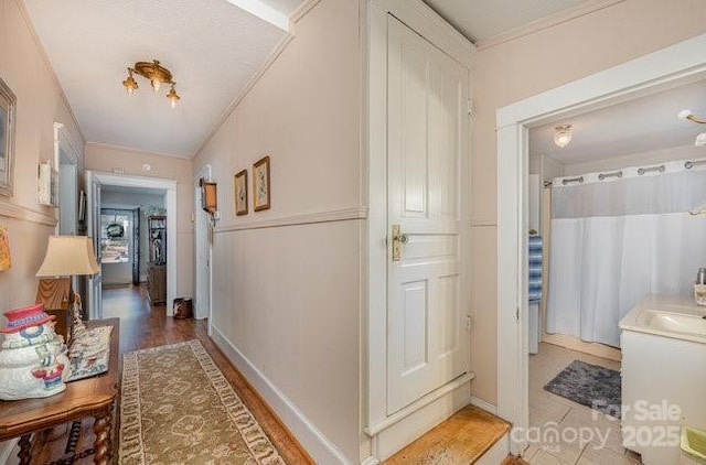 hall with crown molding and wood-type flooring