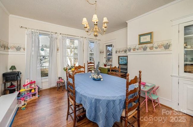 dining room with crown molding, a chandelier, a textured ceiling, and dark hardwood / wood-style flooring