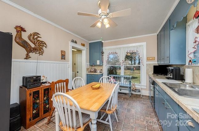 dining room featuring ornamental molding, sink, and ceiling fan