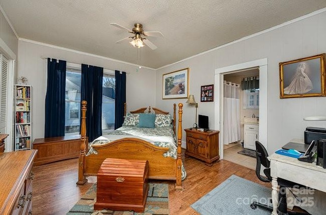 bedroom featuring crown molding, light hardwood / wood-style flooring, and a textured ceiling