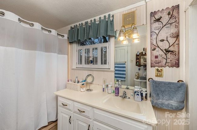 bathroom with vanity and a textured ceiling