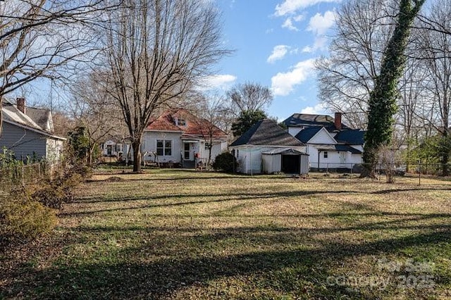 exterior space with a front lawn and a storage unit