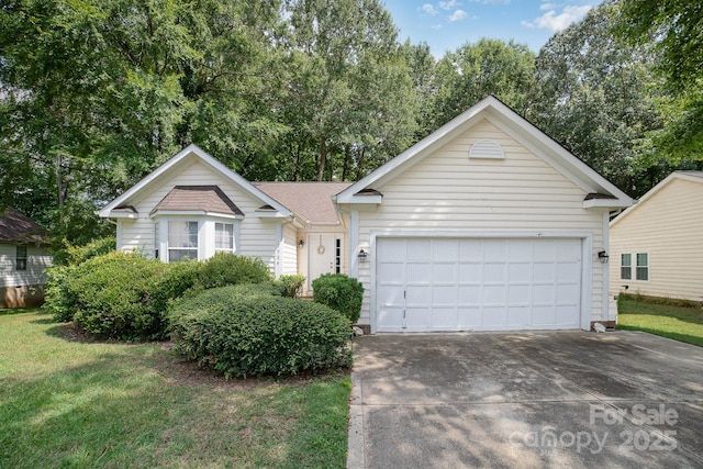 view of front of property with a garage and a front lawn