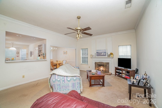 carpeted living room with crown molding, a textured ceiling, and ceiling fan