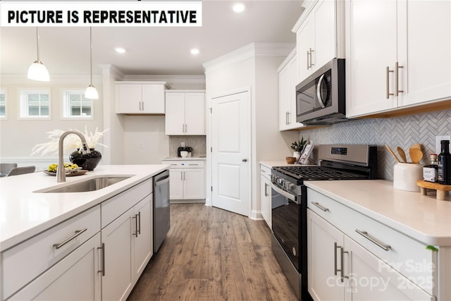 kitchen with appliances with stainless steel finishes, sink, and white cabinets