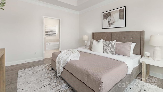 108 Sari St, Troutman, NC 28166 - bedroom with wood finished floors, crown molding, and connected bathroom