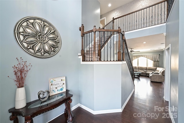 stairs featuring recessed lighting, wood finished floors, a ceiling fan, and baseboards