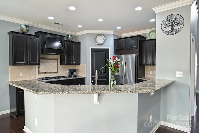 kitchen with premium range hood, light stone counters, stainless steel appliances, and dark wood-type flooring