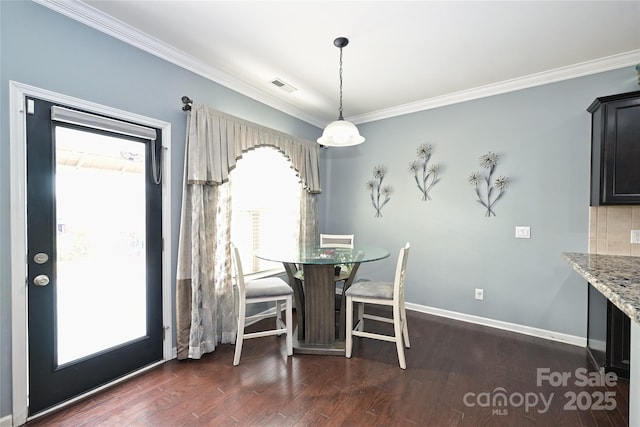 dining space featuring ornamental molding, dark wood-style flooring, visible vents, and baseboards