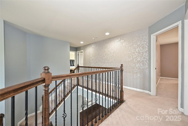 corridor with recessed lighting, carpet floors, an upstairs landing, baseboards, and wallpapered walls