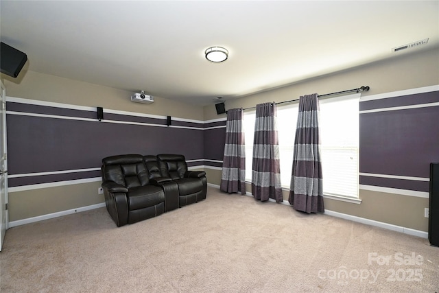 cinema room featuring baseboards, carpet, visible vents, and a healthy amount of sunlight