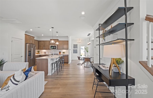 interior space with light hardwood / wood-style flooring and sink