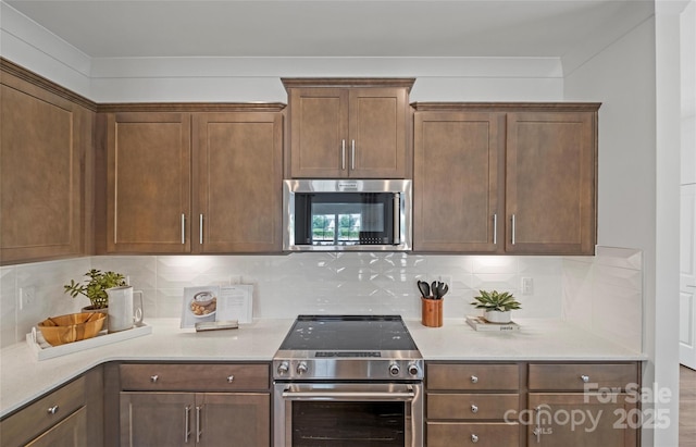 kitchen featuring appliances with stainless steel finishes and backsplash