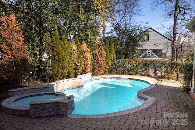 view of swimming pool with an in ground hot tub