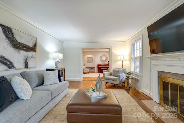 living room featuring ornamental molding and light hardwood / wood-style floors