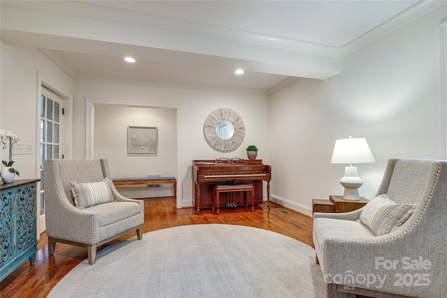 sitting room featuring hardwood / wood-style flooring and ornamental molding