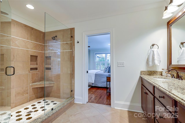 bathroom featuring crown molding, vanity, and walk in shower