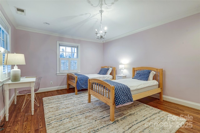 bedroom with hardwood / wood-style floors, crown molding, and a chandelier