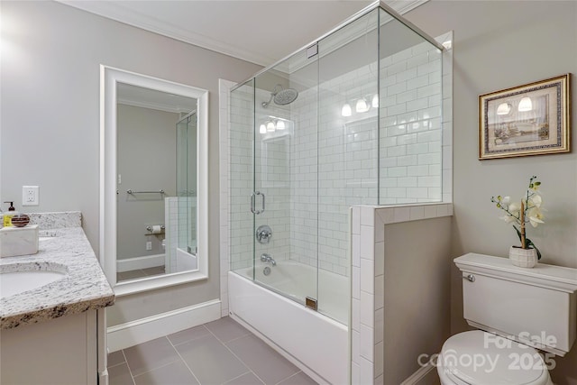 full bathroom featuring shower / bath combination with glass door, vanity, toilet, crown molding, and tile patterned floors