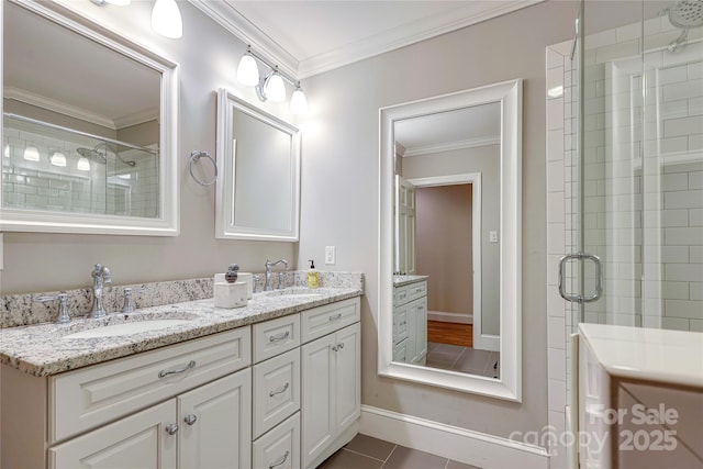 bathroom featuring ornamental molding, a shower with shower door, tile patterned flooring, and vanity