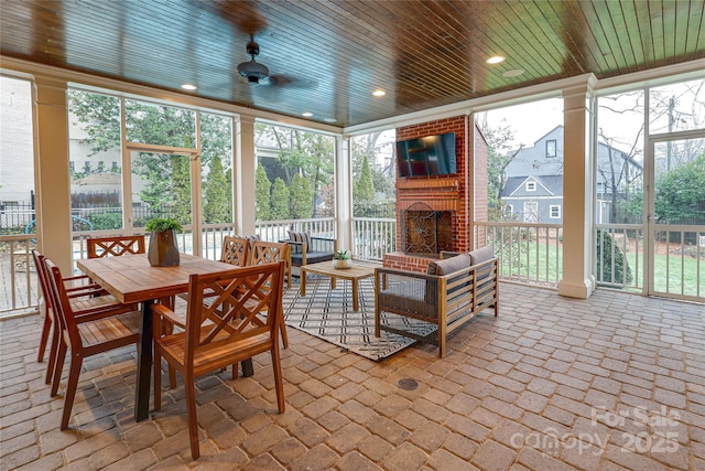 sunroom / solarium with ceiling fan and wooden ceiling