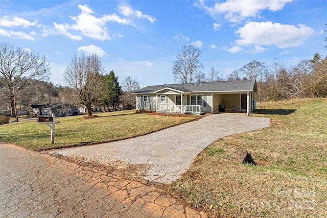 ranch-style house with covered porch, a front lawn, and a carport