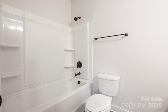 bathroom with shower / washtub combination and toilet