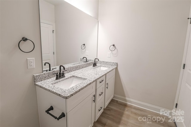 bathroom featuring vanity and hardwood / wood-style flooring