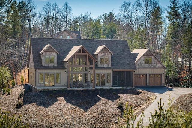 view of front of house featuring a garage and central AC