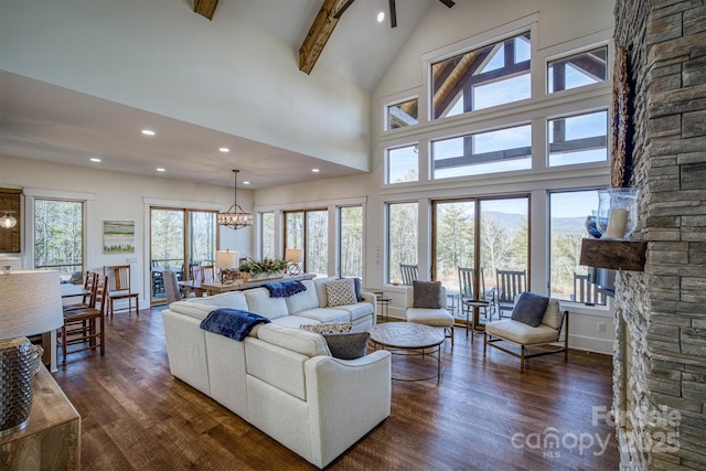 living room featuring beam ceiling, dark wood-type flooring, high vaulted ceiling, and a chandelier