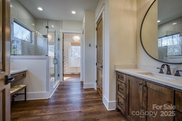 bathroom featuring vanity, hardwood / wood-style floors, and a shower with door