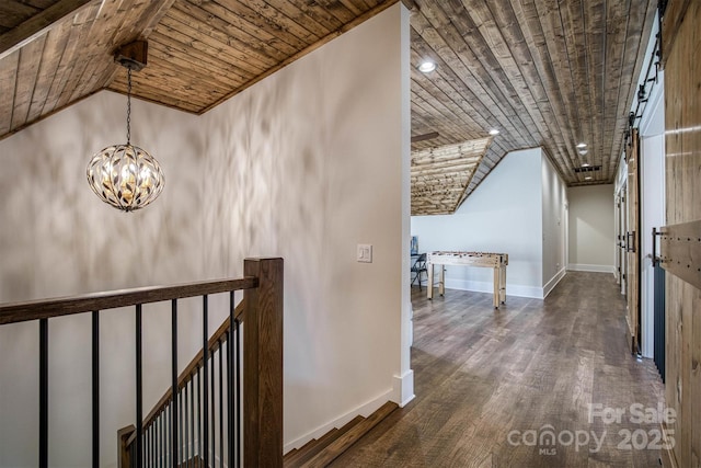 hall featuring wood ceiling, lofted ceiling, dark hardwood / wood-style flooring, and a notable chandelier