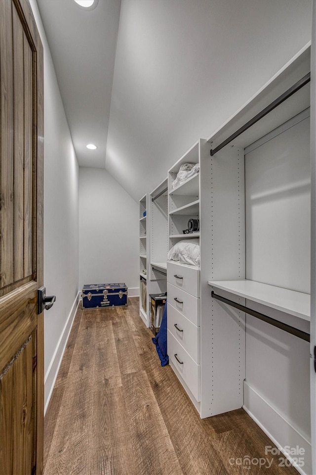 walk in closet featuring lofted ceiling