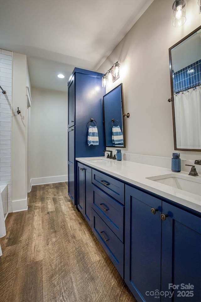 bathroom with hardwood / wood-style flooring and vanity