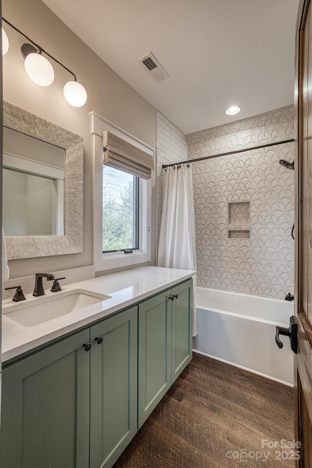 bathroom featuring shower / tub combo and vanity