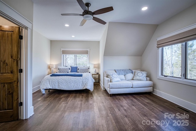 bedroom featuring ceiling fan, dark hardwood / wood-style flooring, and vaulted ceiling