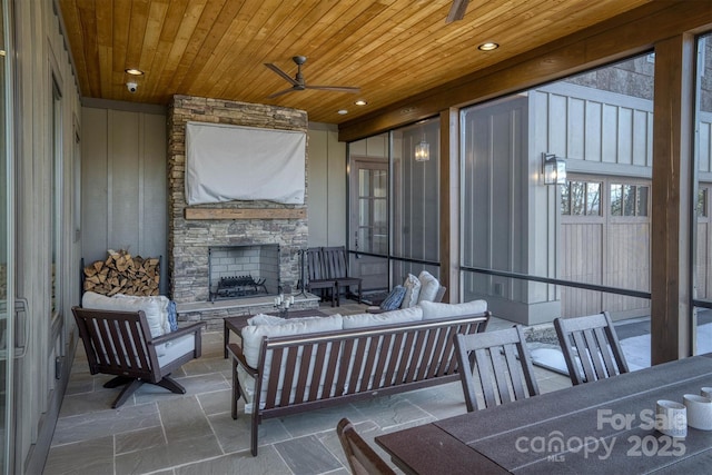 view of patio / terrace featuring an outdoor living space with a fireplace and ceiling fan