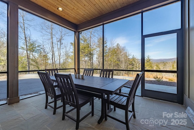 unfurnished sunroom with wood ceiling