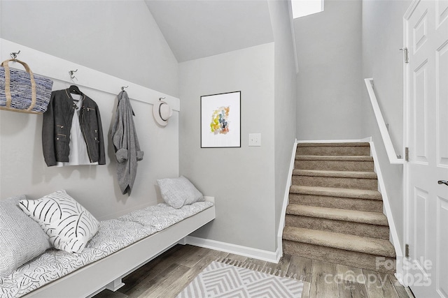 mudroom with wood-type flooring and vaulted ceiling