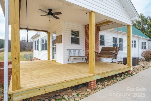 wooden deck with central AC unit and ceiling fan