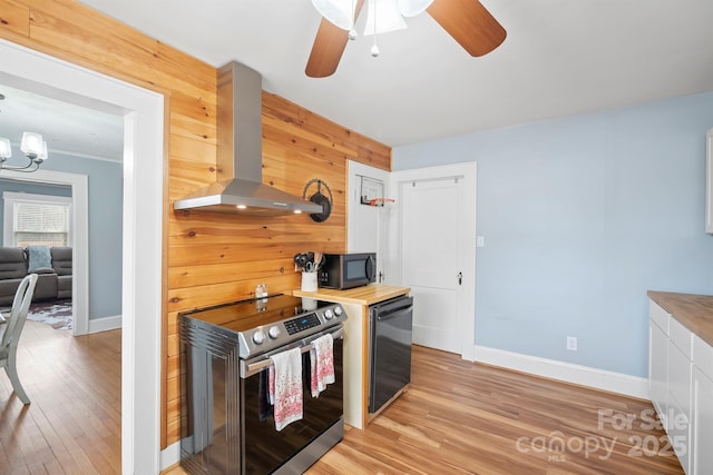 kitchen with light wood-type flooring, ventilation hood, white cabinets, and stainless steel electric range oven